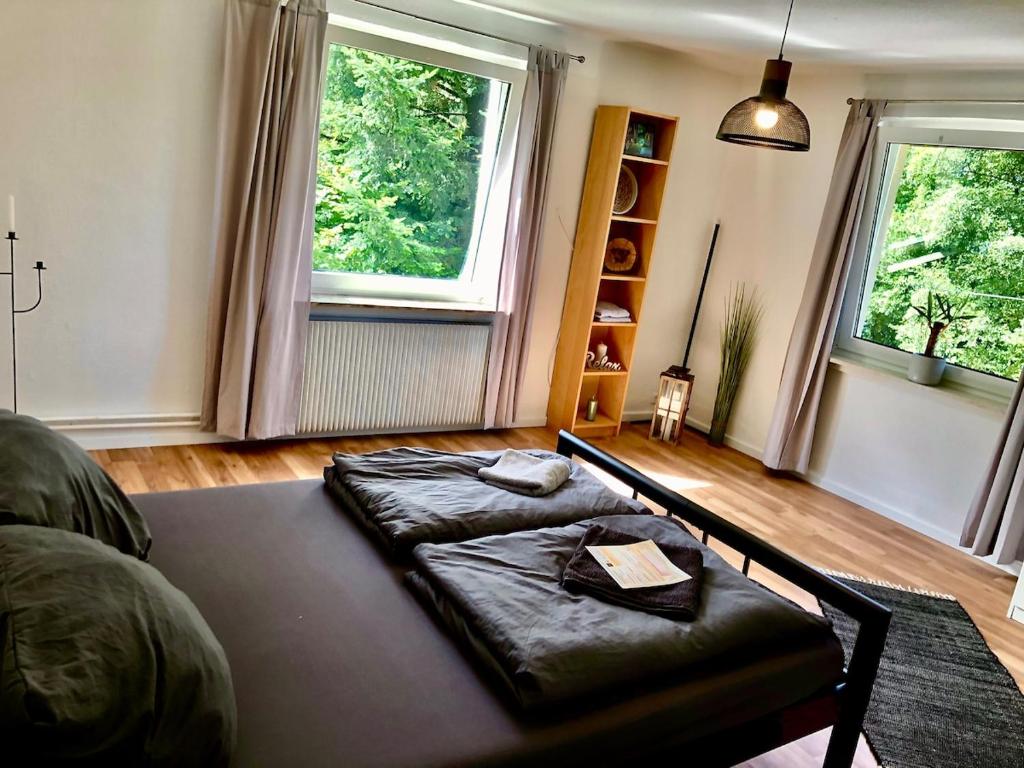 a living room with a couch and two windows at Ferien im Schwarzwald Ferienwohnung Freiamt in Freiamt