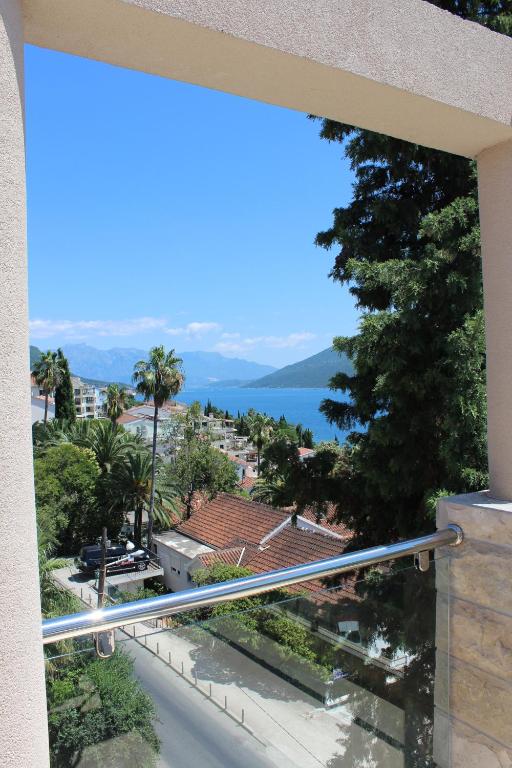 a view from a window of a street and a lake at Swiss Residence Montenegro in Herceg-Novi