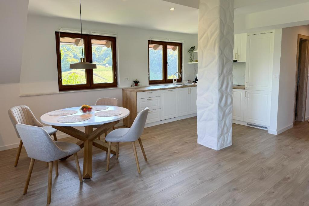a kitchen and dining room with a table and chairs at Cherry Hill Loft in Plitvička Jezera