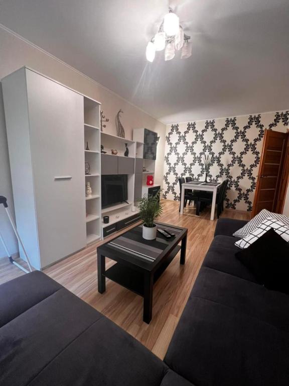 a living room with a couch and a coffee table at 2BR Apartment - Free Parking, WiFi, Self Check-in in Klaipėda