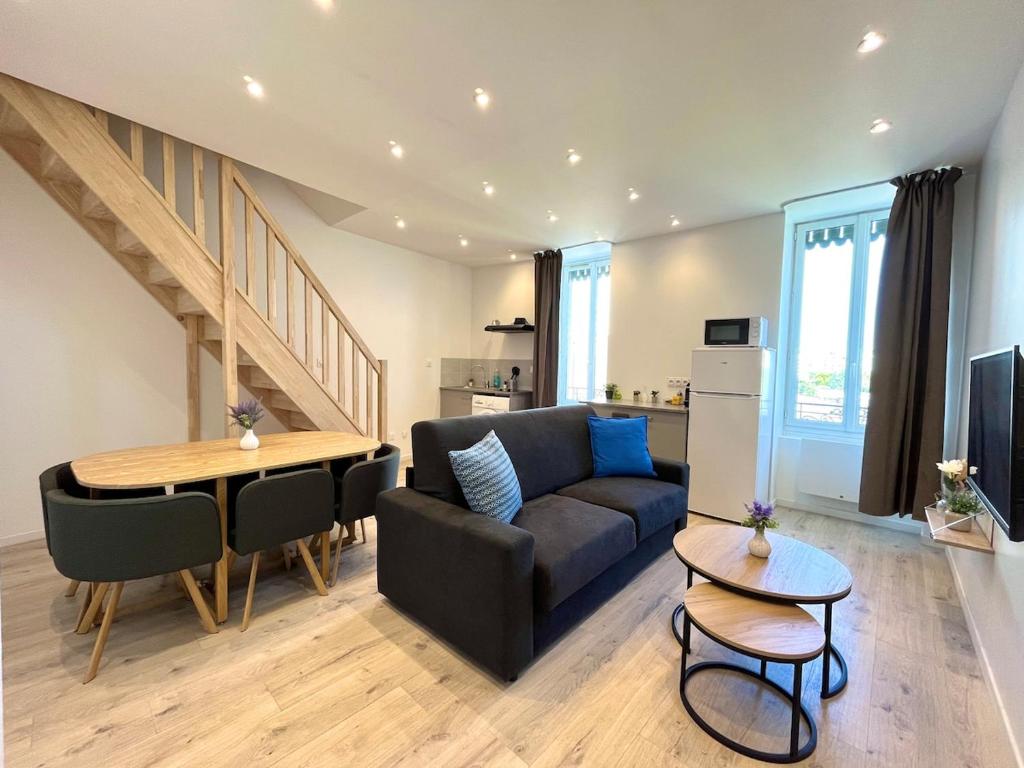 a living room with a couch and a table at Duplex urbain proche centre-ville de Lyon in Lyon