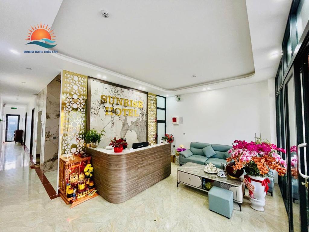 a lobby of a store with a couch and flowers at Sunrise Hotel Thiên Cầm in Ha Tinh