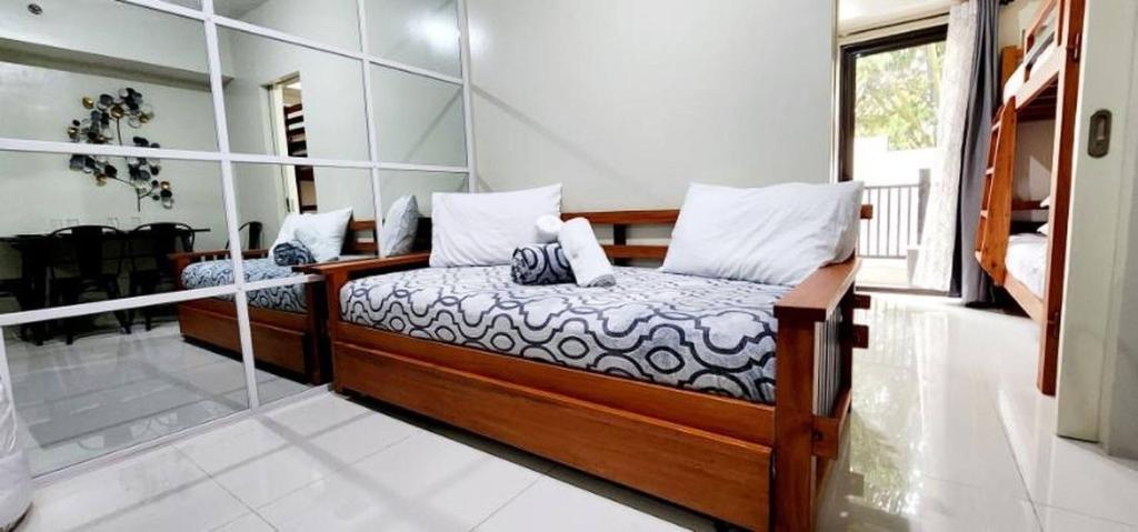 a bedroom with a bed and a glass wall at LG318 New Brenthill Premium Condo near SMBaguio in Baguio