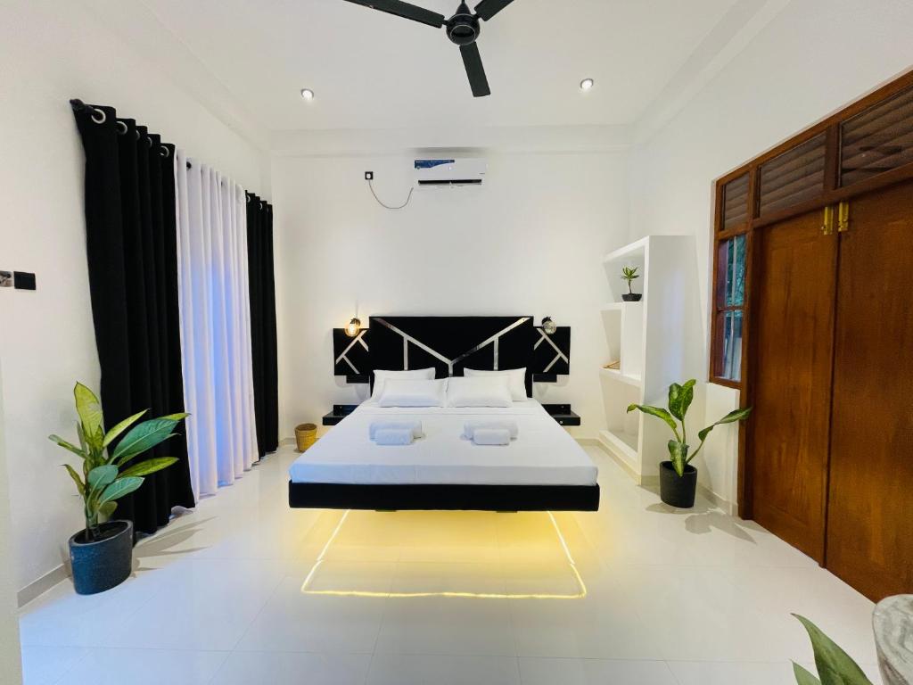 a bedroom with a large bed in a room at Oasis Villa in Dickwella