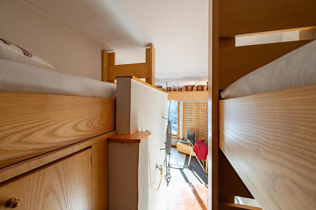 a bedroom with a bunk bed and a room with a balcony at G3 appartamento 21 Pila- Gressan in Pila