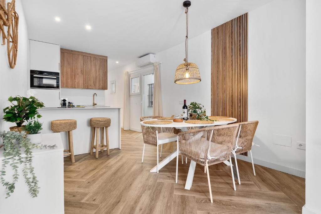 a kitchen and dining room with a table and chairs at Casa Rija - Renovated 2BR - Heart of Mijas Pueblo in Mijas