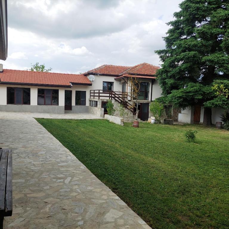 a house with a green lawn in front of it at Коларова къща in Avren