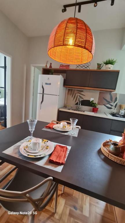 a kitchen with a table with plates of food on it at Seu Loft em BH, conforto e localização perfeita in Belo Horizonte