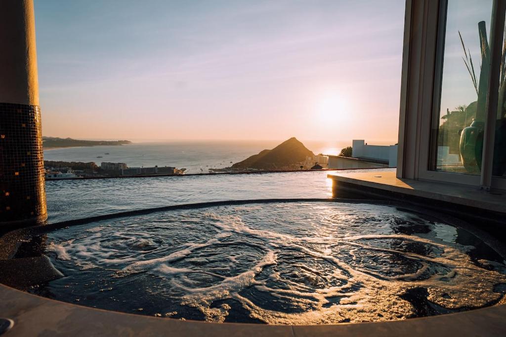 a bath tub with a view of the ocean at Luxury Cabo Villa Stunning Ocean Views in Cabo San Lucas
