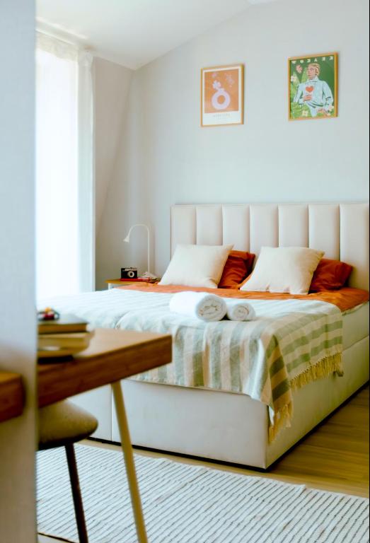 a white bed in a bedroom with a table at Kątowa Studio - Sauna, AC, balcony in Krakow