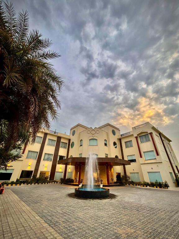 a building with a fountain in front of a building at Kaara Gurgaon in Gurgaon