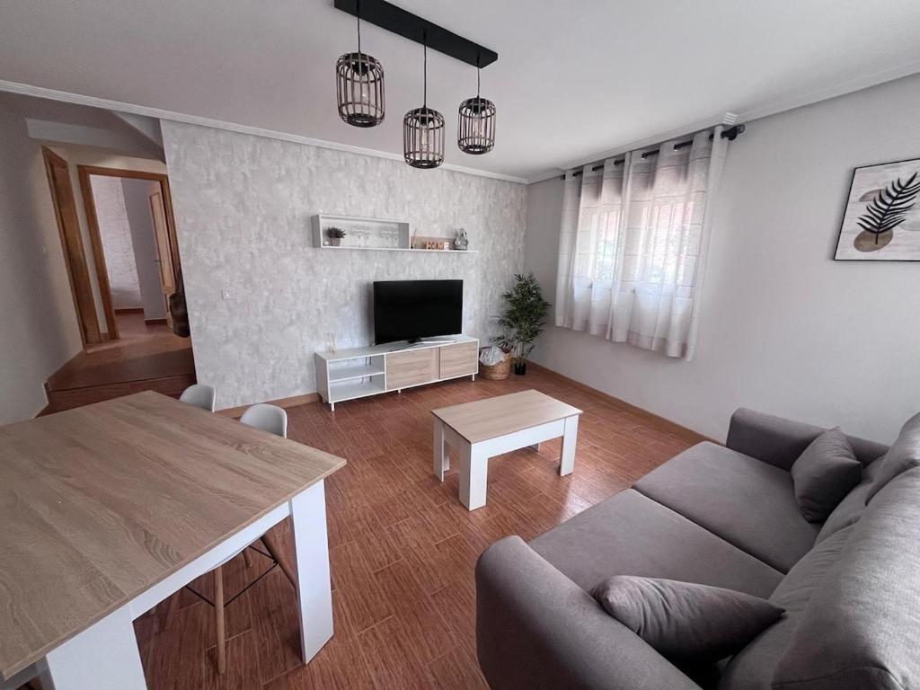 a living room with a couch and a table at La Casita de Irene in Olmedo