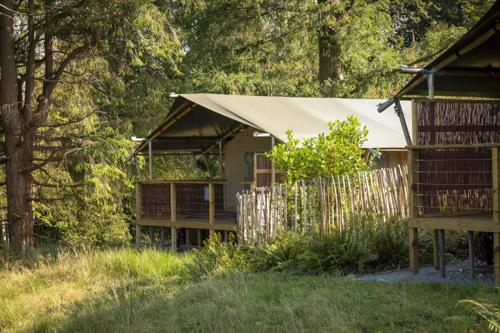 a house with a tent in the woods at Windermere - Safari Suite in Ambleside