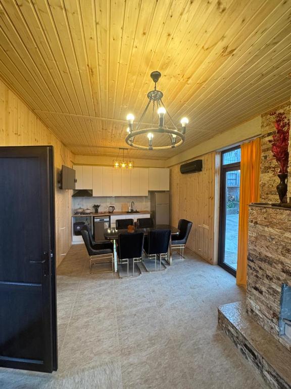 a kitchen and dining room with a table and chairs at Tsikhisdziri Home in Ts'ikhisdziri
