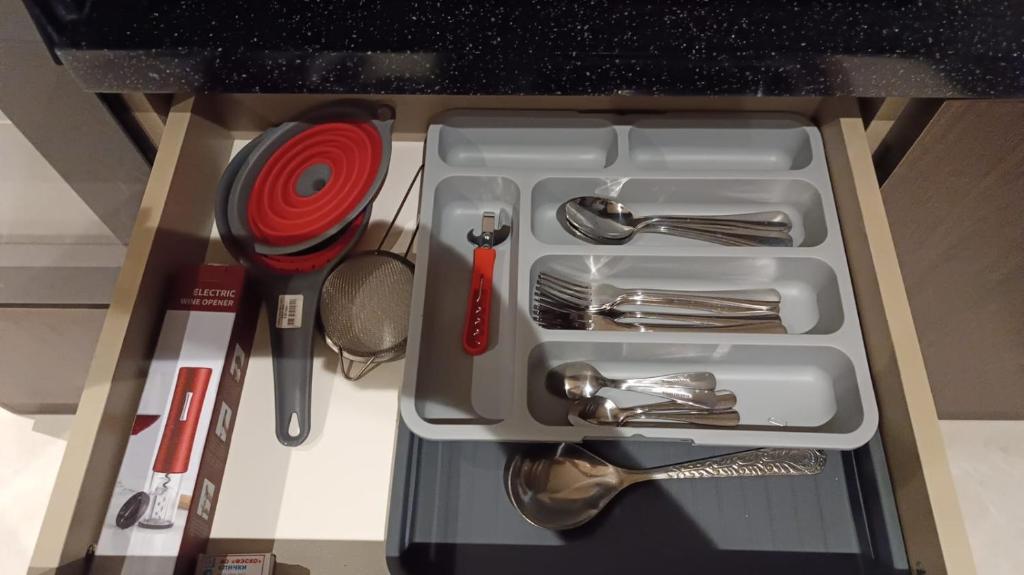 a white tray with utensils in a drawer at Seabreeze Park Residence 2 in Nardaran