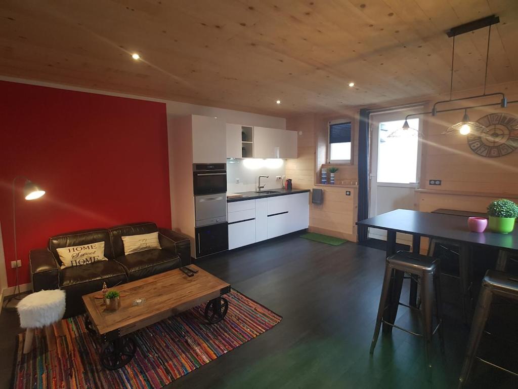 a living room with a couch and a table at Le Fournil du Couvent in Les Rousses