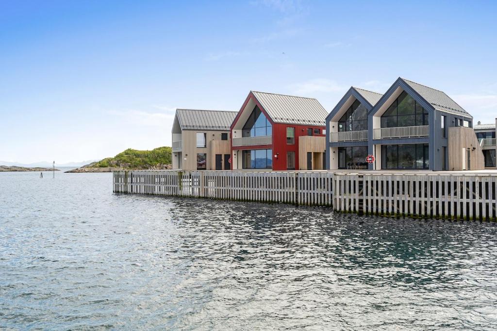 a house on a dock in the water at Rorbuleilighet Lysøya 1H in Henningsvær