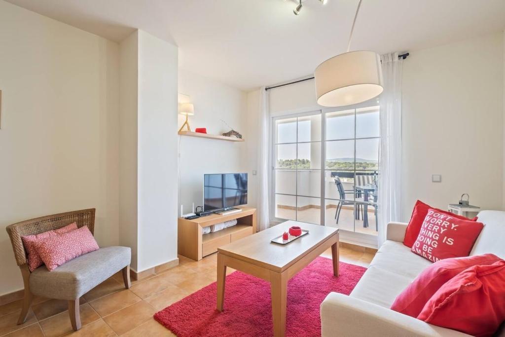 a living room with a couch and a table at Casa del Color - Alcaidesa in San Roque