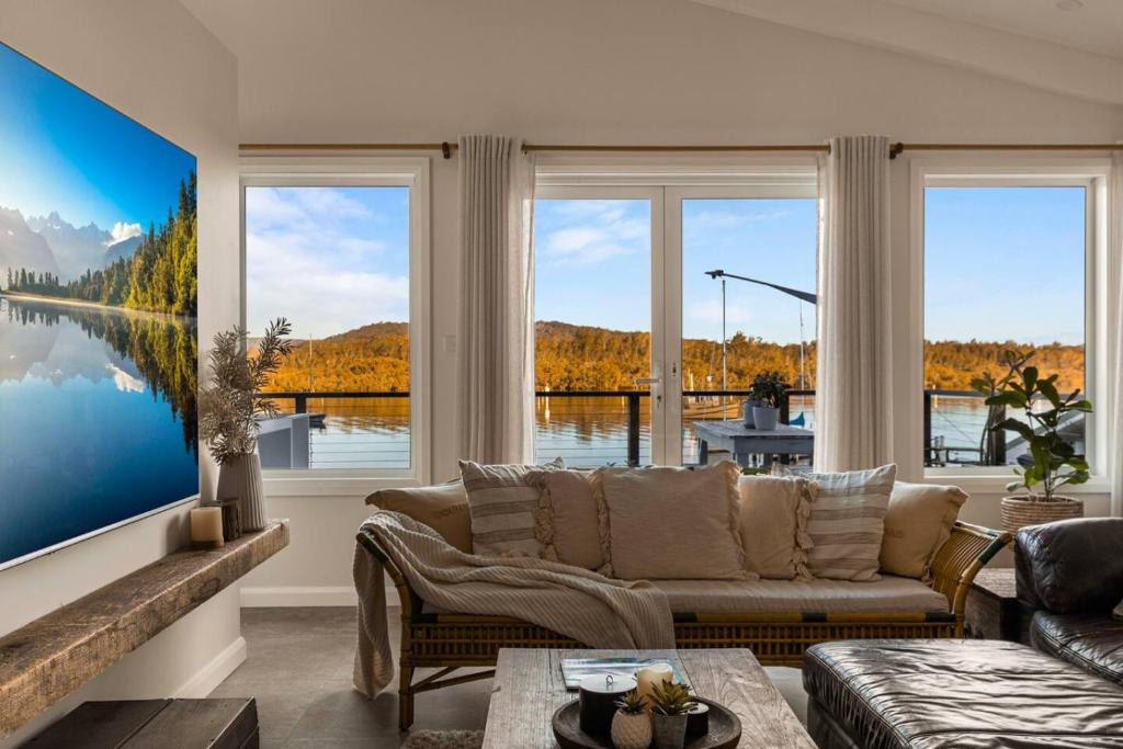 a living room with a couch and large windows at Henderson House in Saratoga