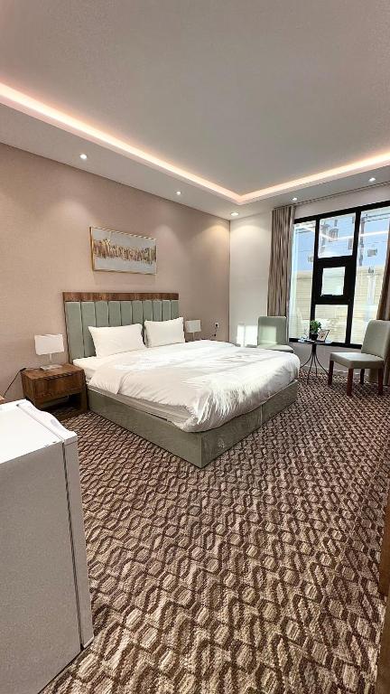 a bedroom with a large bed and a large rug at Roaa Al-Jamwaut in Medina