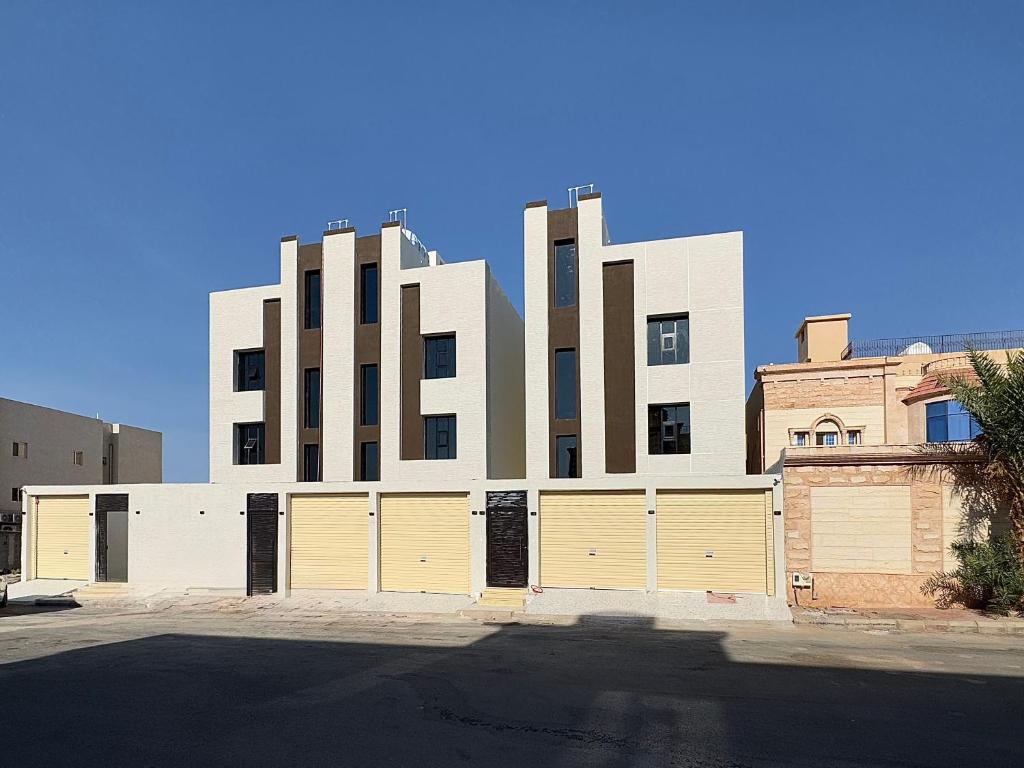a building with two garage doors in front of it at Roaa Al-Jamwaut in Al Madinah