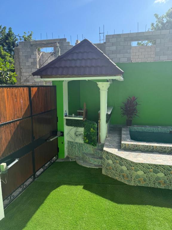 a backyard with a gazebo and grass at Hidden mansion in Kingston
