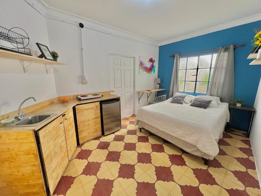 a bedroom with a bed and a sink in it at Urban Hotel in Guatemala