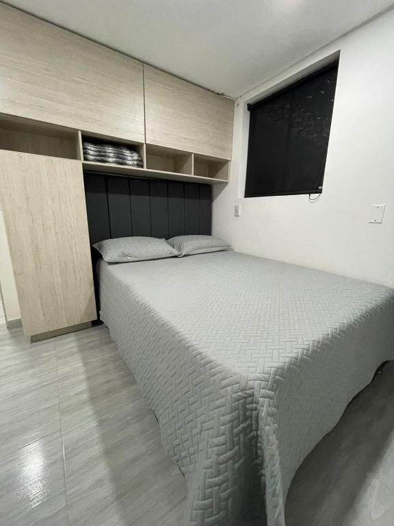 a bedroom with a large bed with a window at Hotel boutique Olaya 54 in Medellín