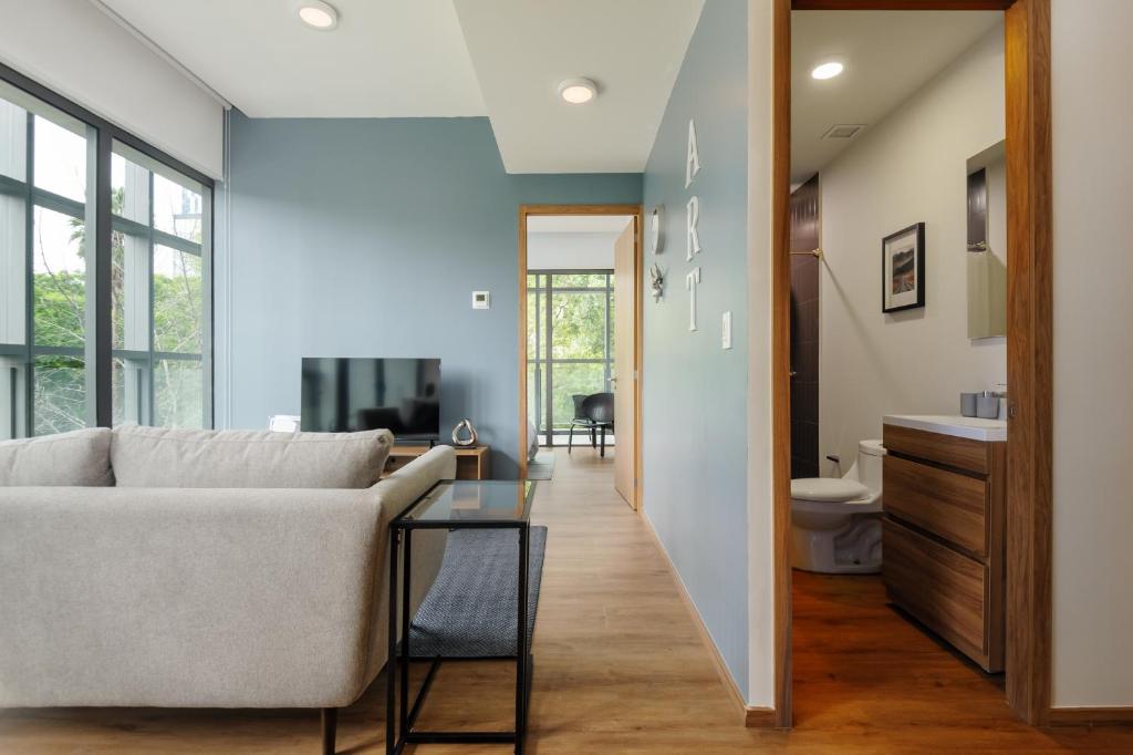 a living room with a couch and a television at Pet-friendly Furnished 1BR Rental in Mexico City in Mexico City