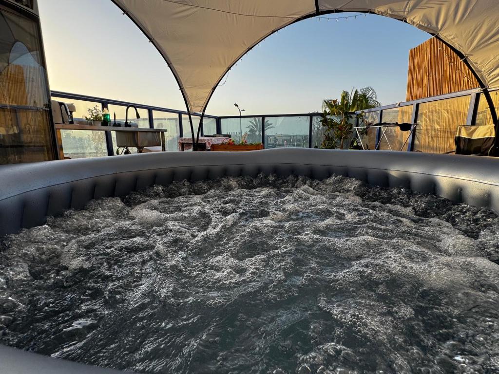 a hot tub on the roof of a building at Swita Nir - Hot tub in Ashdod