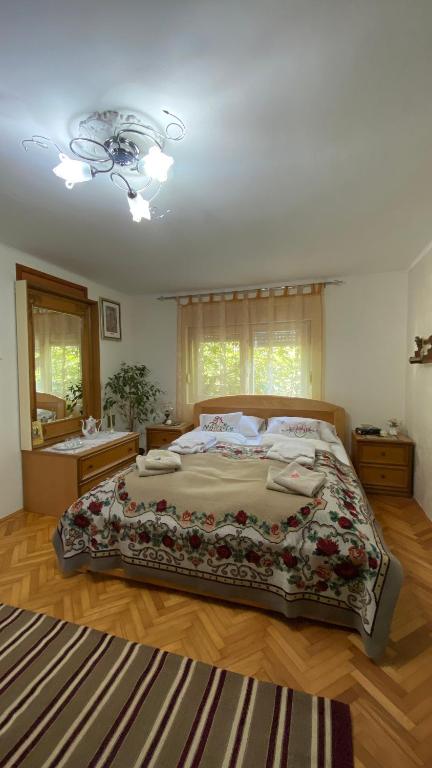 a bedroom with a large bed and a bathroom at Topole in Stapar