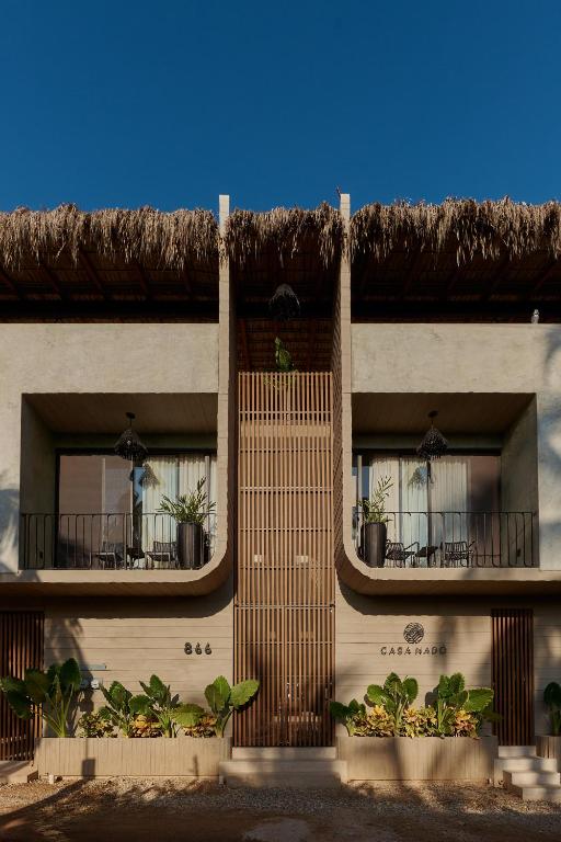 a building with two balconies with potted plants on them at Casa Nadó in Brisas de Zicatela