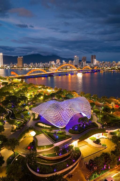 a view of a city at night with a building at ORANGE Hotel &amp; Suites - Danang City CENTER, near Dragon Bridge in Da Nang