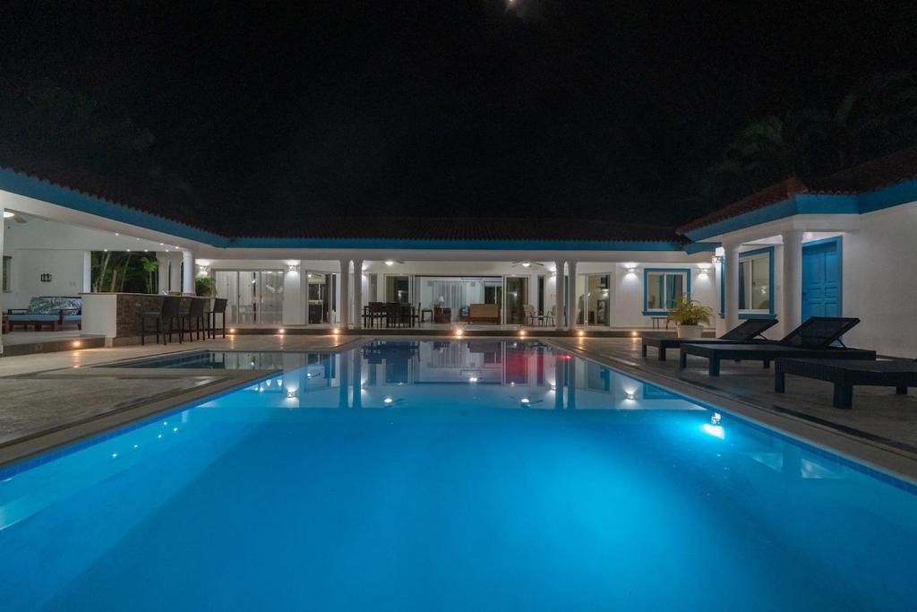 a swimming pool at night with blue lights at Space Freedom Connection in Sosúa