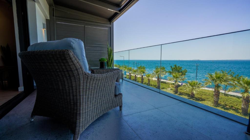 a balcony with chairs and a view of the ocean at RUKA Hotel in Narlıdere