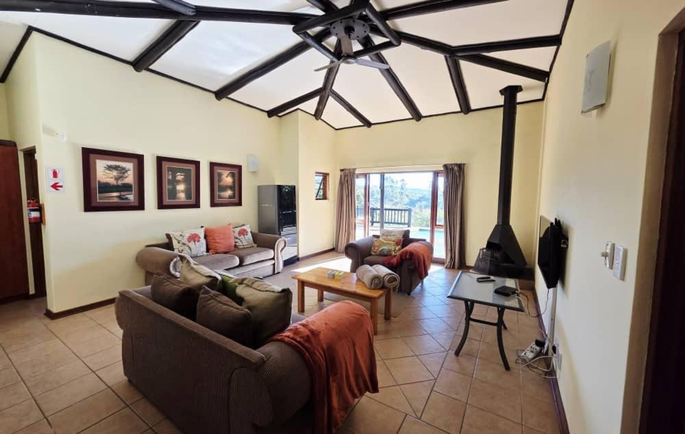 a large living room with couches and a ceiling at Bush Willow Lodge in Hazyview