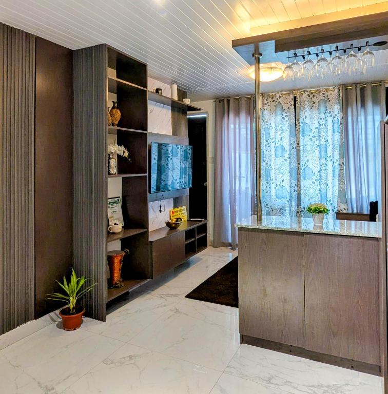 a living room with a counter and a television at Cityloft Guesthouse in Tagbilaran City