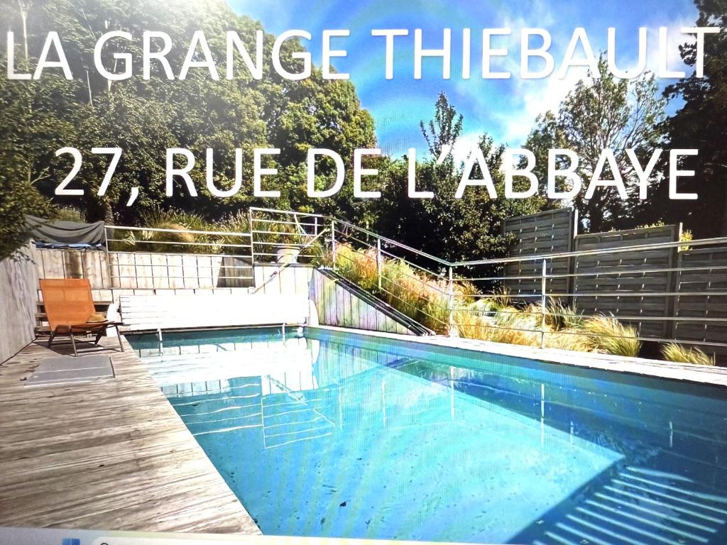 a blue swimming pool with the words la grange theabase deliver at Villas sommebay Pour un séjour de rêve in Miannay