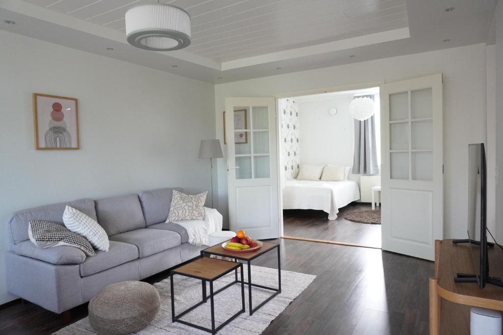 a living room with a couch and a table at Near Santa Village with Free Parking in Rovaniemi