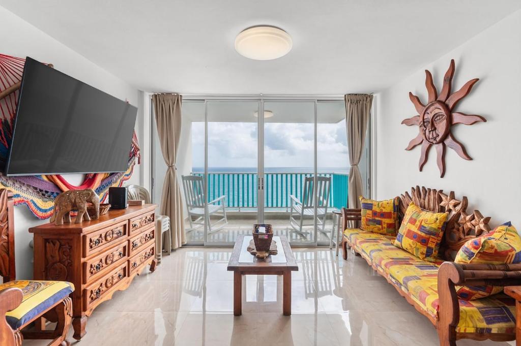 a living room with a couch and a flat screen tv at The Best View in Luquillo Beach Front View in Luquillo