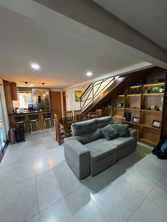 a living room with a couch and a dining room at Casa Lençóis Maranhenses in Barreirinhas