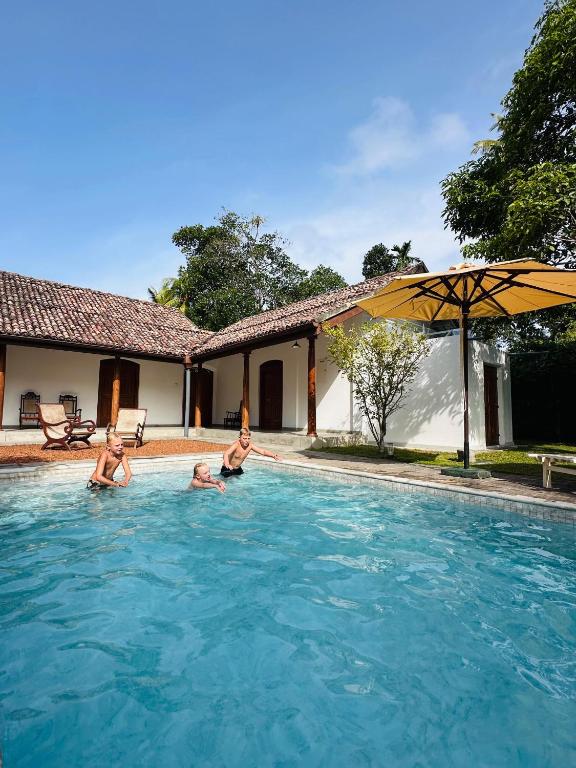 a group of people in a swimming pool at Kurundu Walawwa Villas and Suites by The Clarks in Ahungalla