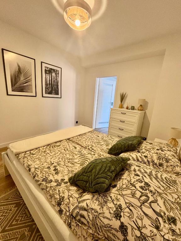 a bedroom with a bed with two pillows on it at Apartament pod Świerkami in Pisz