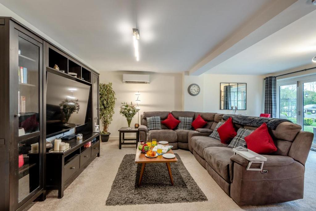 a living room with a couch and a table at Autumn Barn Annexe in Smarden