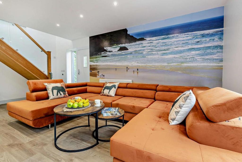 a living room with a couch and a table at Trevone in Saint Mawgan