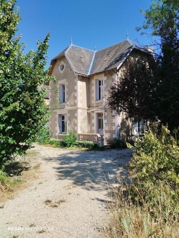 an old stone house on a dirt road at Les Studios Grenouilles in Chasseneuil-du-Poitou