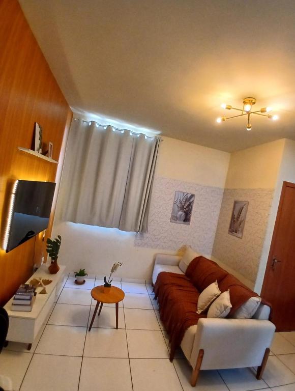 a living room with a couch and a table at Apartamento COP 30 in Ananindeua