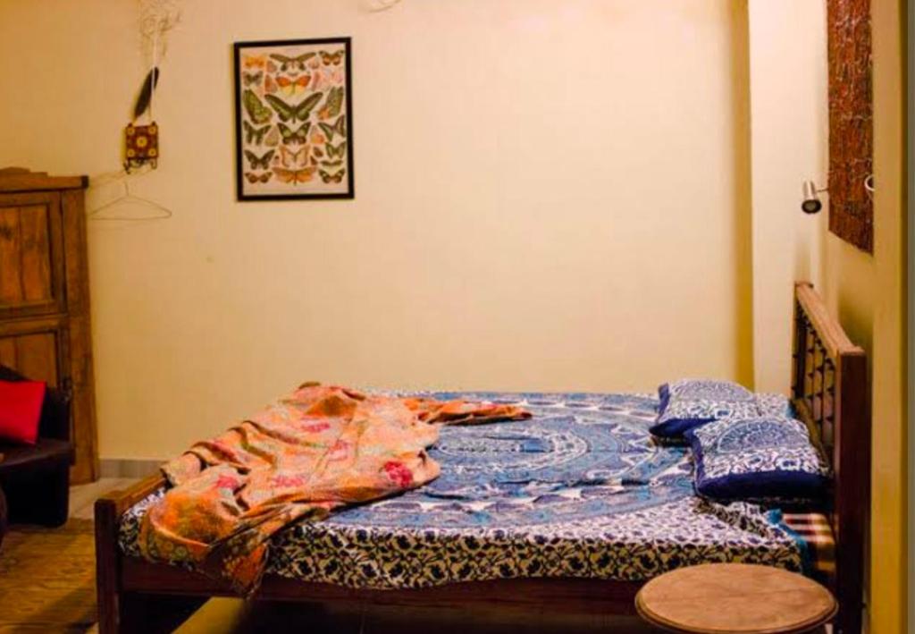 a bedroom with a bed with a quilt on it at Goswami property in Jaipur