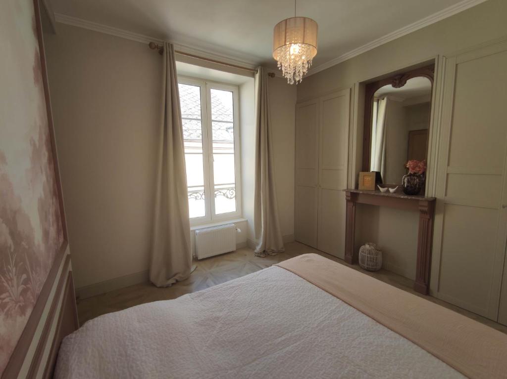 a bedroom with a bed and a large window at Ô Bulles de Loire, Châteauneuf-sur-Loire in Châteauneuf-sur-Loire