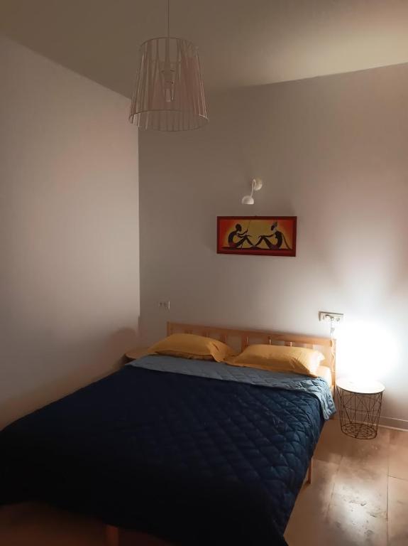 a bedroom with a bed with a blue comforter at Casa IRI - plaja Corbu in Corbu